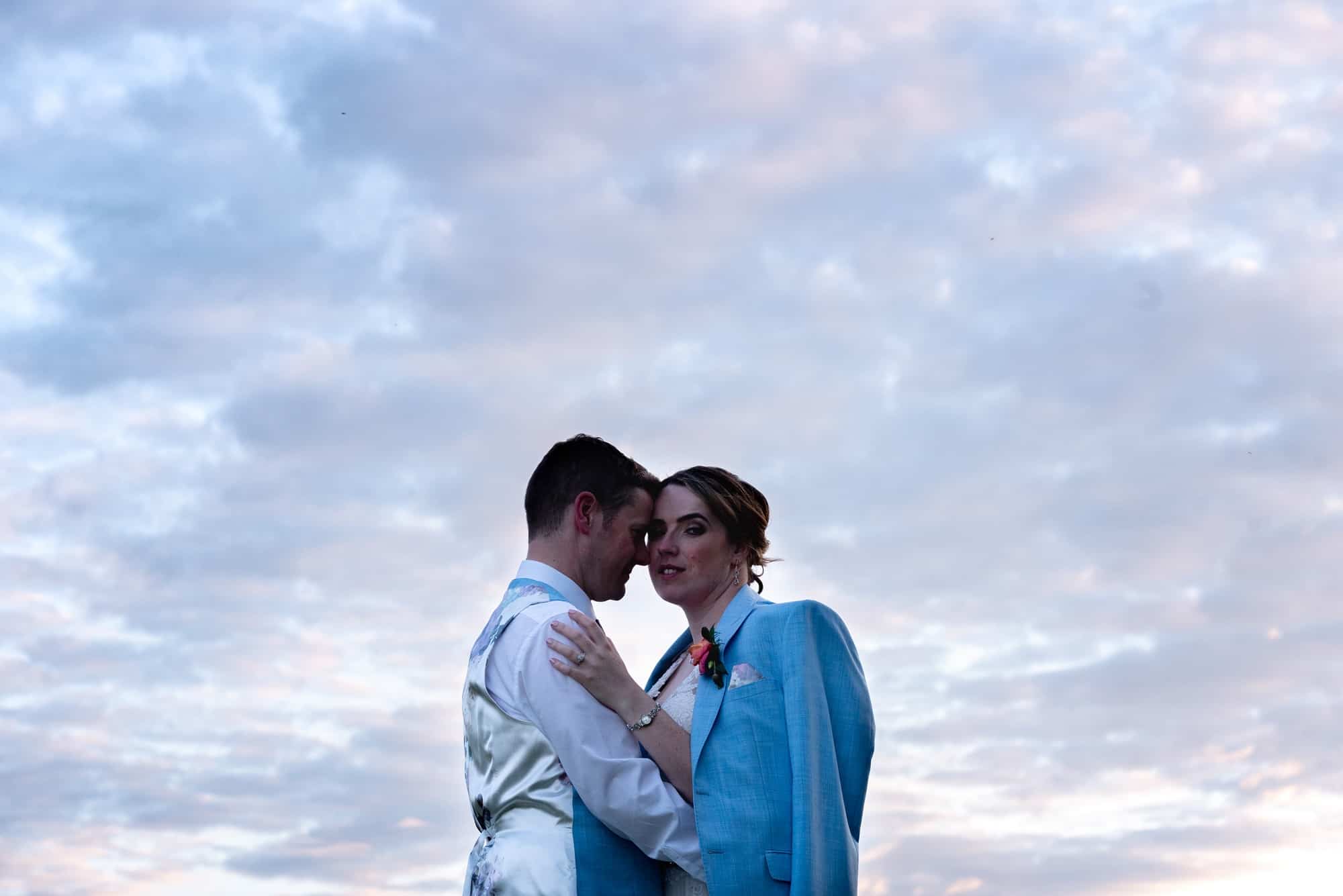 Portrait of bride and groom with beautiful colours and sky photo at Hawk Conservancy in Andover on their wedding day