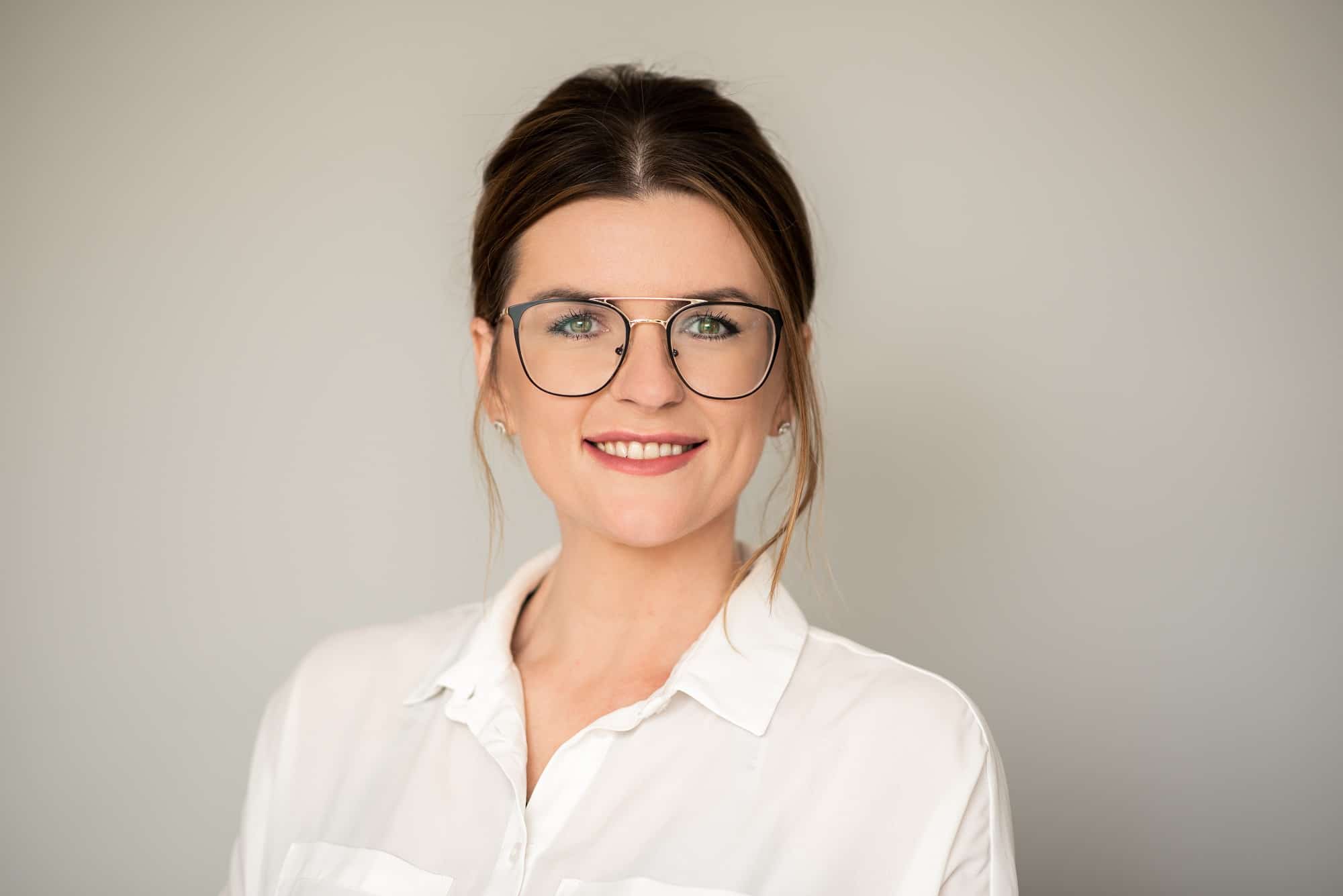 Staff portrait of a woman in glasses for the company she works for