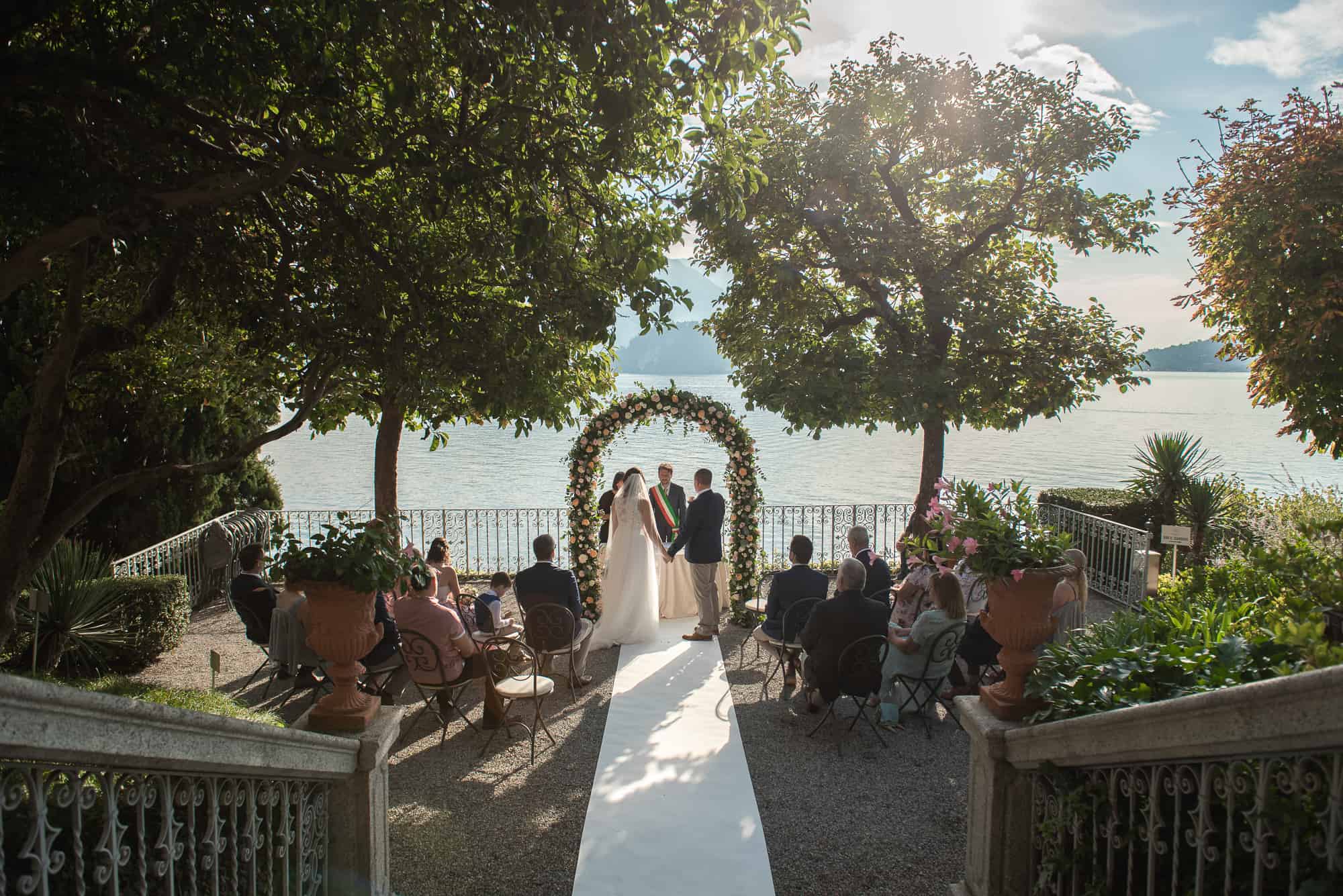Wedding ceremony on lake como, Italy, couple stood under pergola
