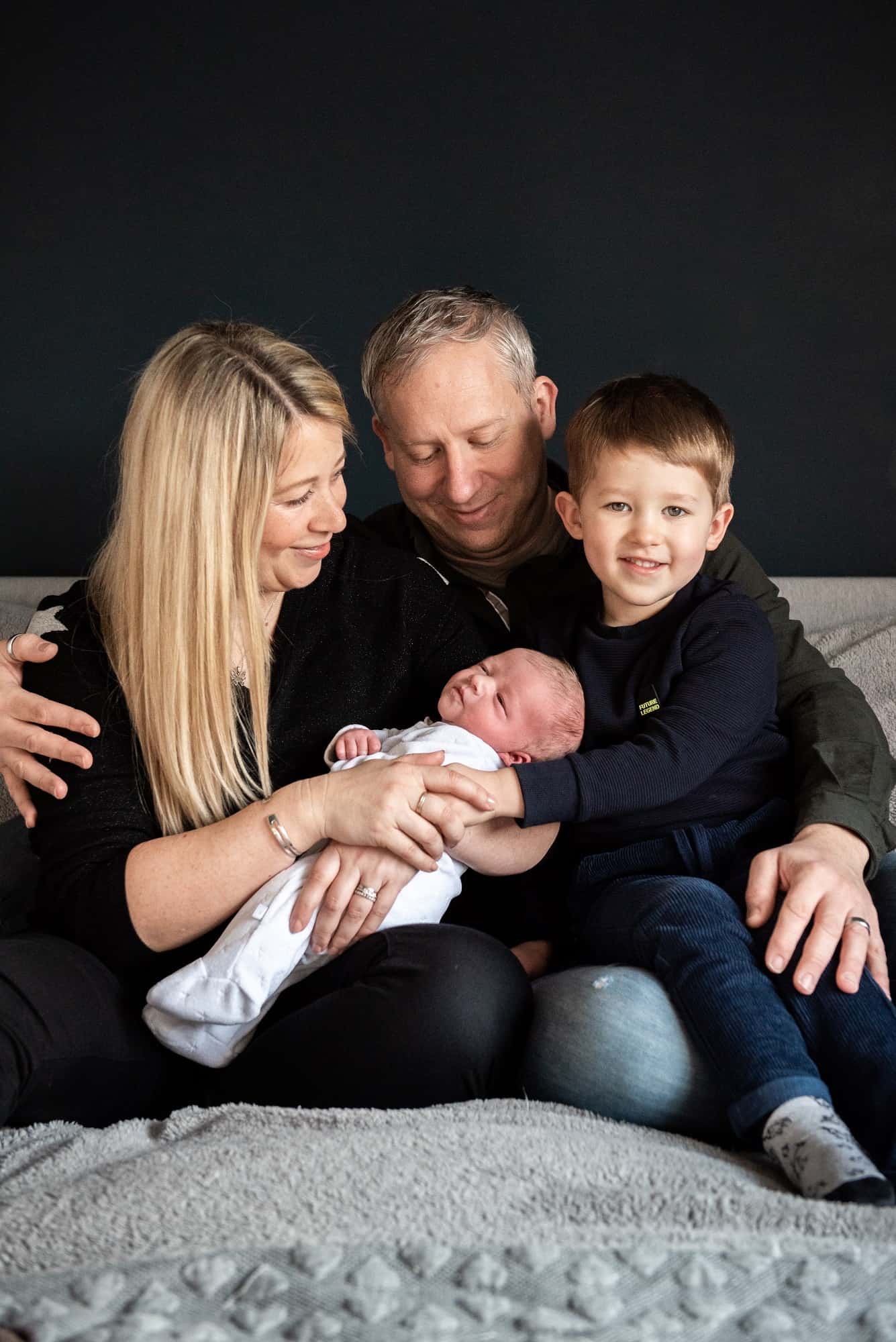 Family with their newborn baby for a photos in their home in southampton