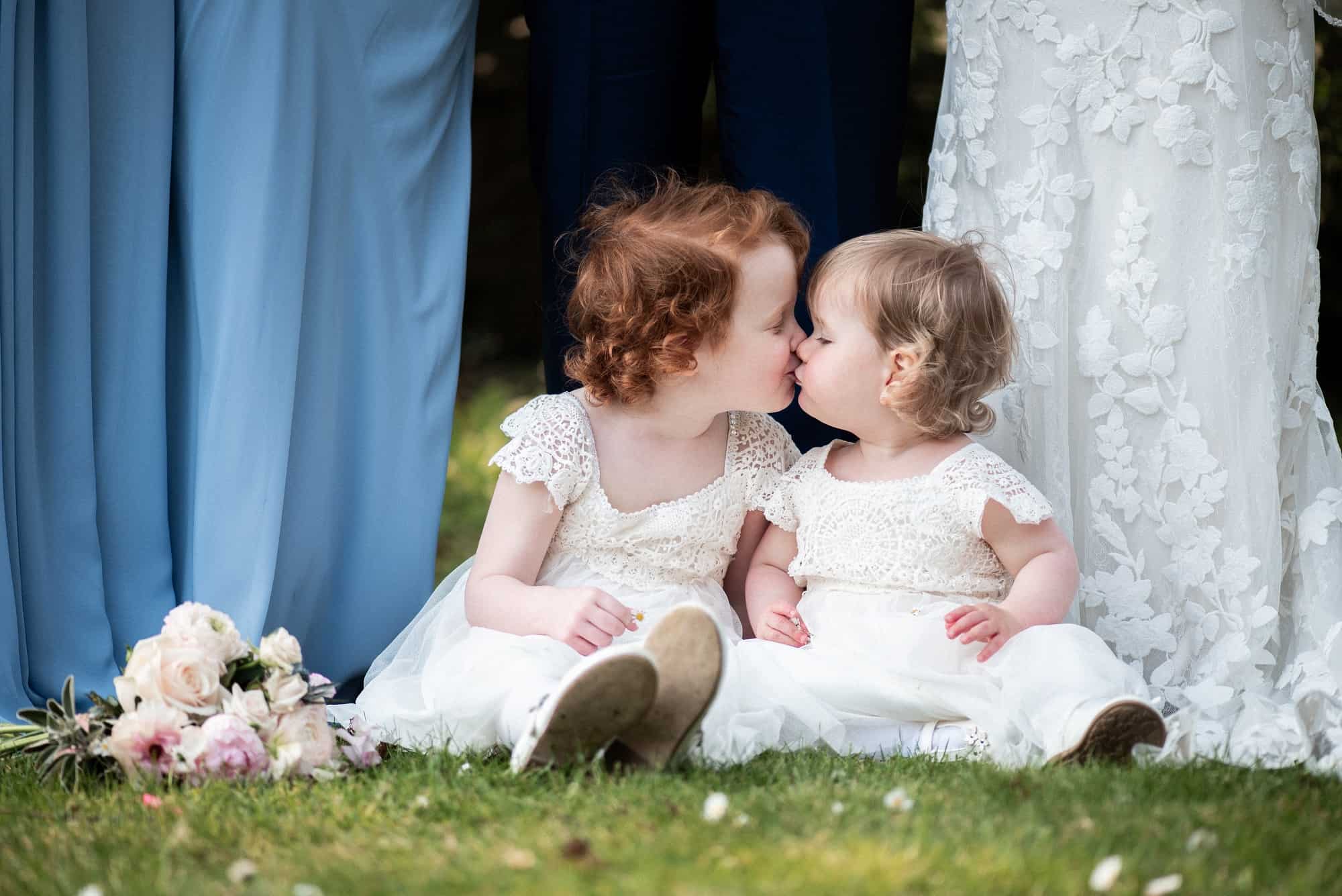 flower girls sat on the grass playing